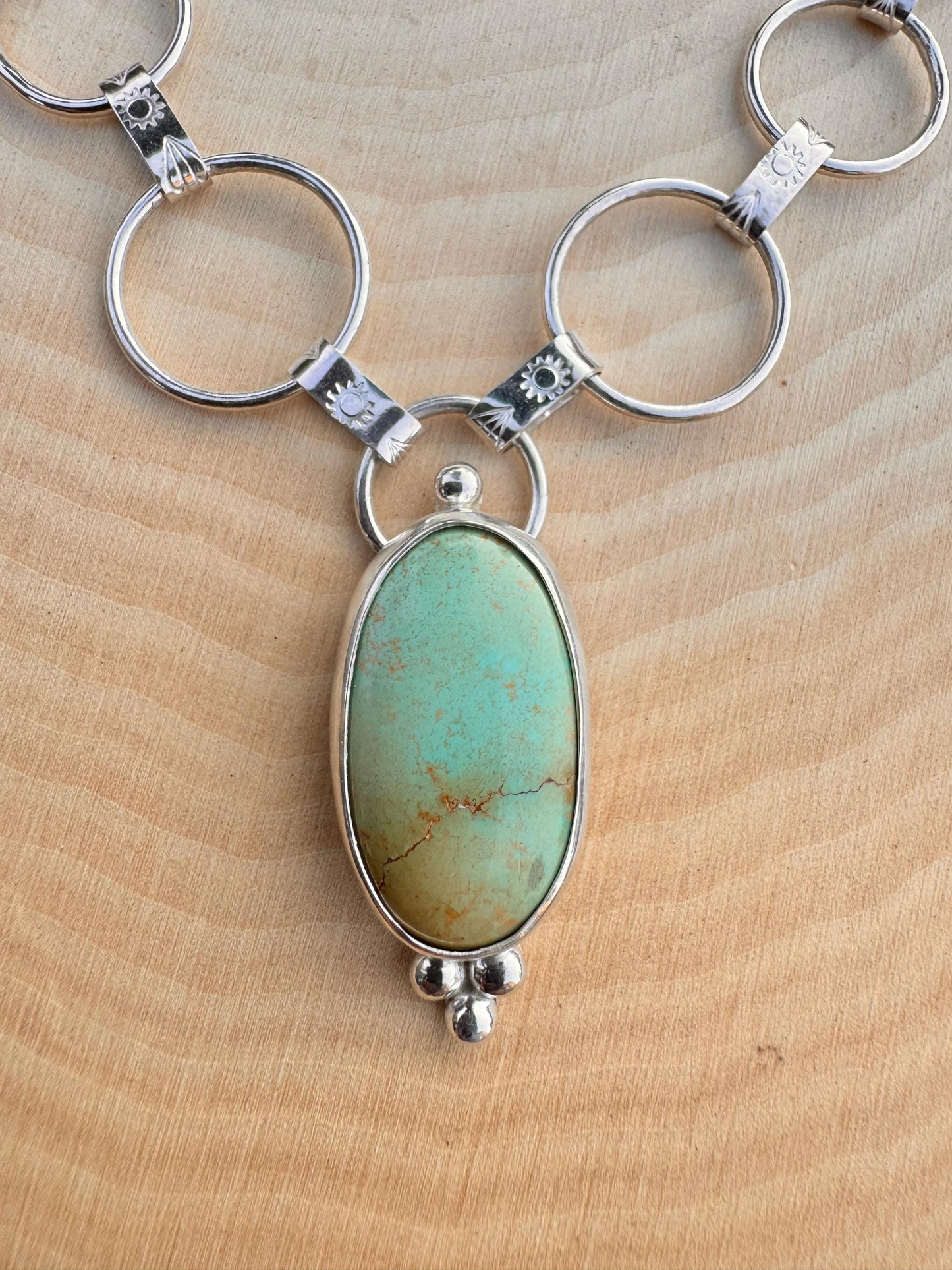 Artisan sterling silver chain with hand-forged textured links and Royston turquoise centerpiece.