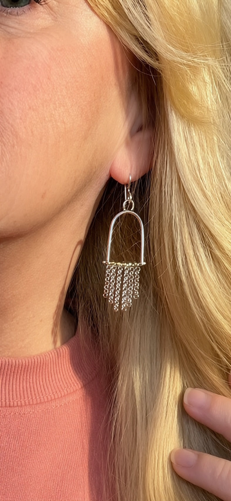 Sun Salt Silver Arizona Peridot arch earrings worn on ear, chain fringe movement, desert-inspired handcrafted jewelry