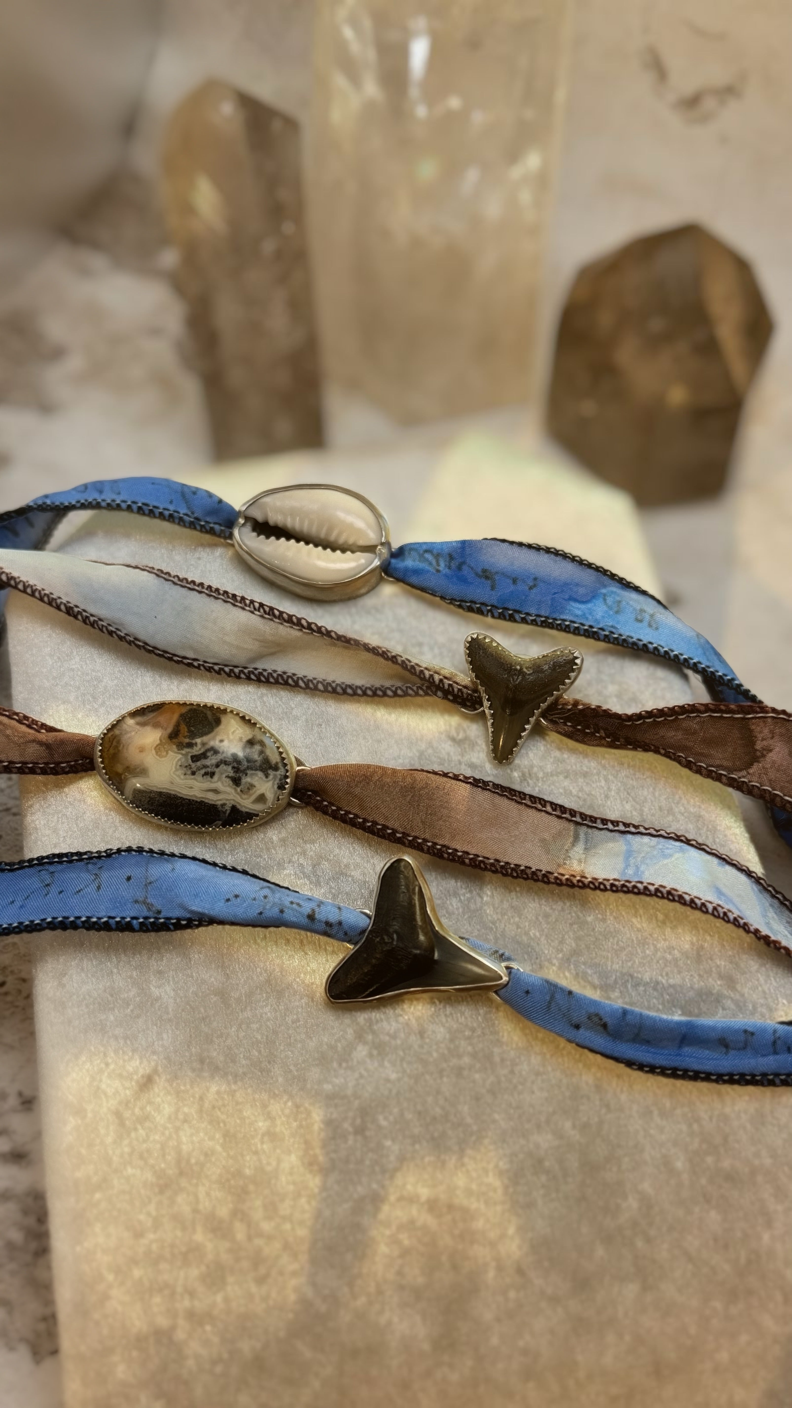 Set of colorful bracelets with decorative elements on a textured surface