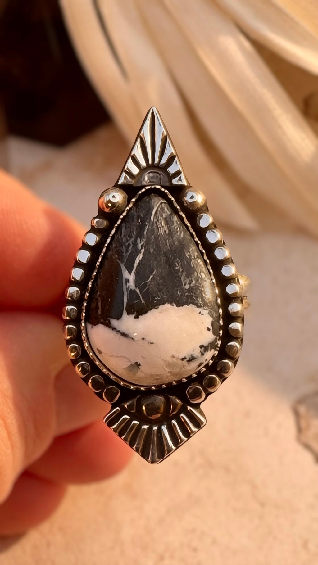 White Buffalo statement ring set in fine and sterling silver with sculptural sunburst details.