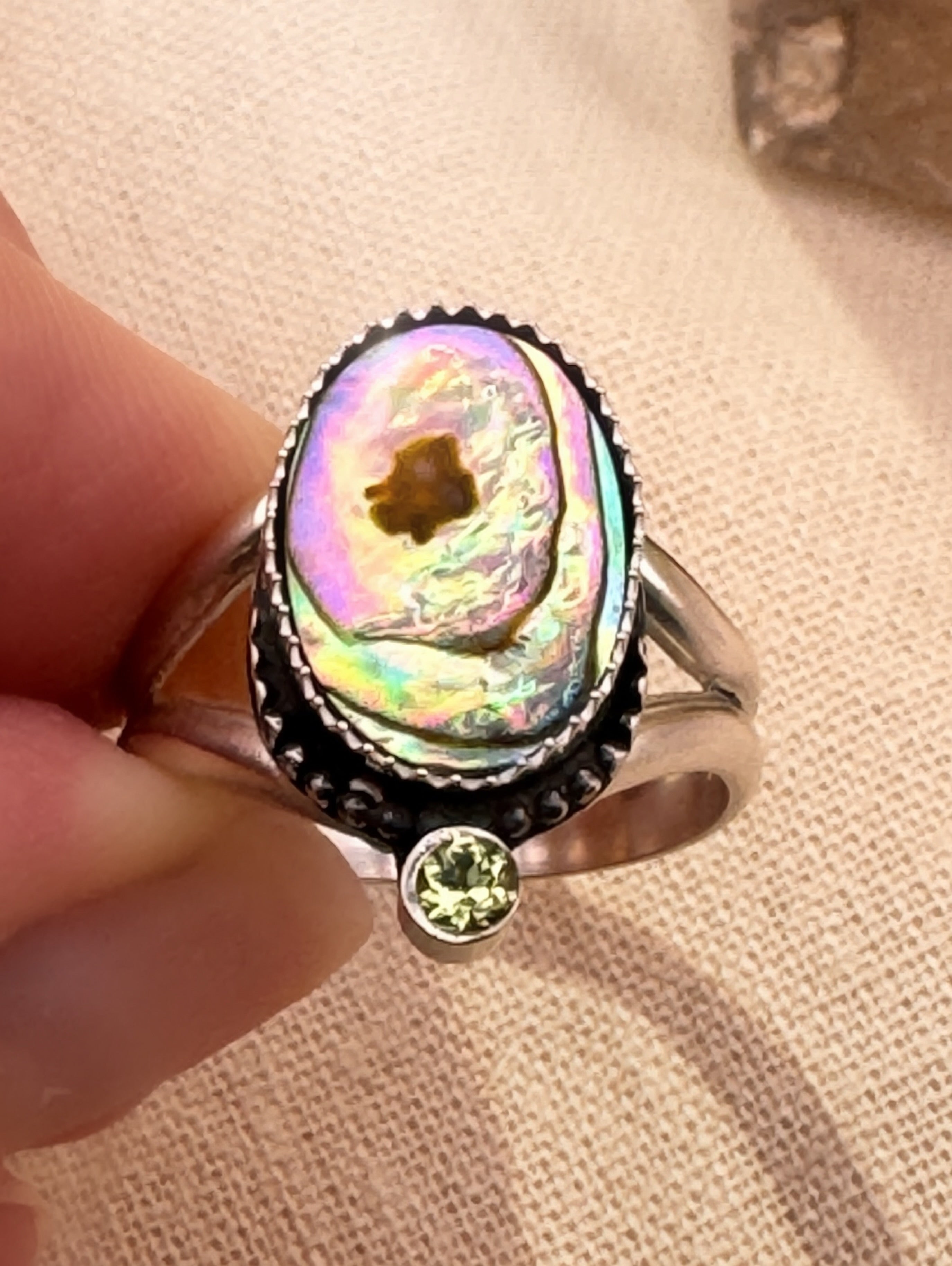 One of a kind sterling silver ring featuring abalone and peridot gemstone