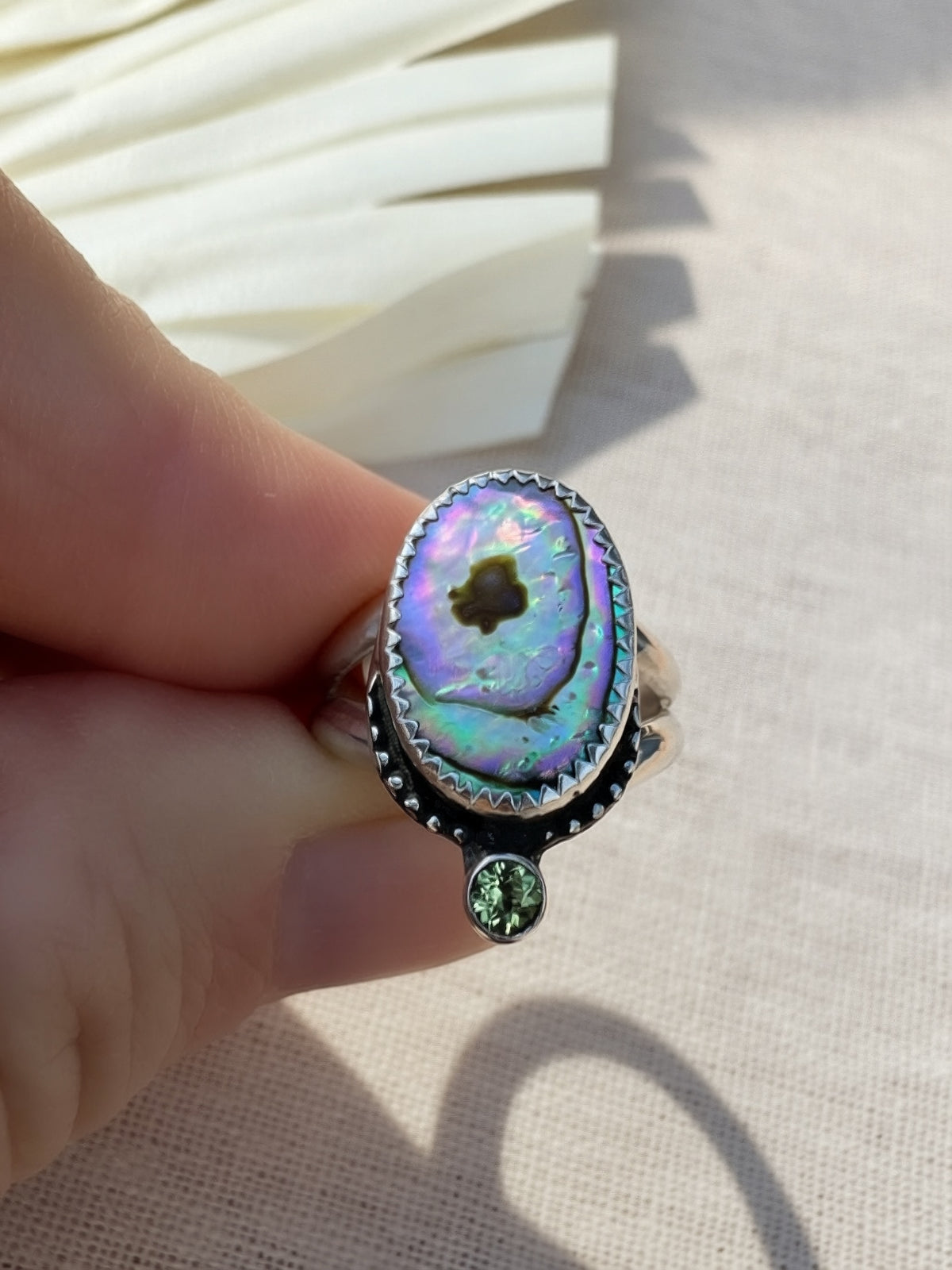 Handcrafted abalone and peridot ring in oxidized sterling silver with split shank band
