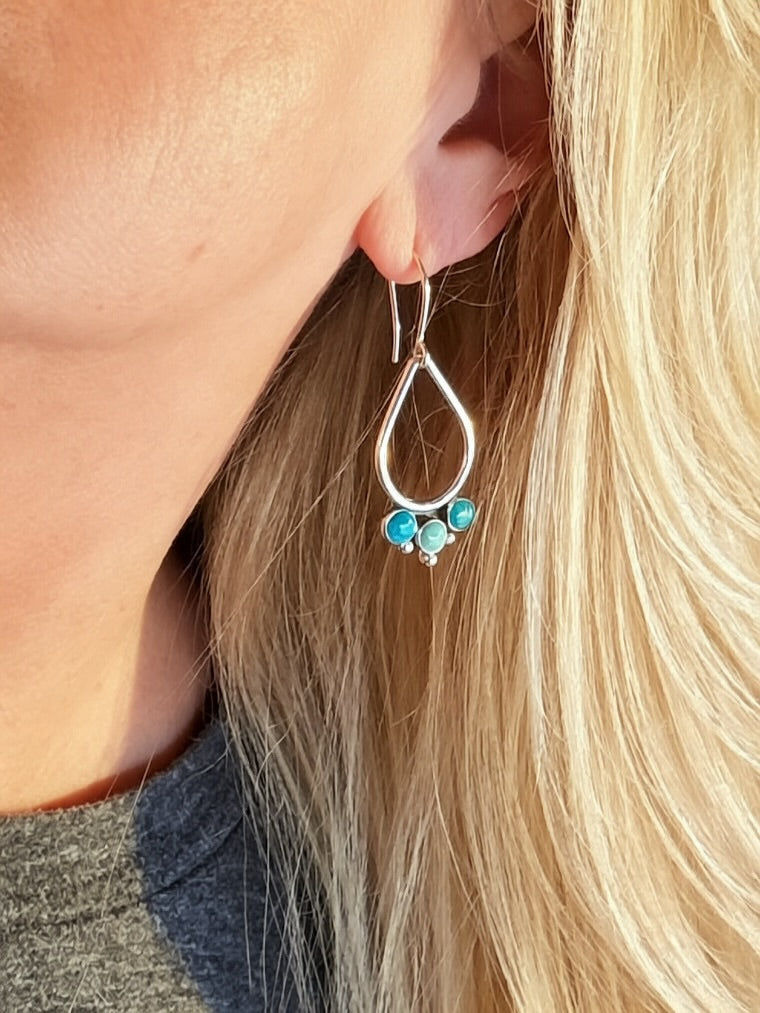 Handmade sterling silver teardrop earring with Kingman turquoise cluster worn on ear, Sun Salt Silver