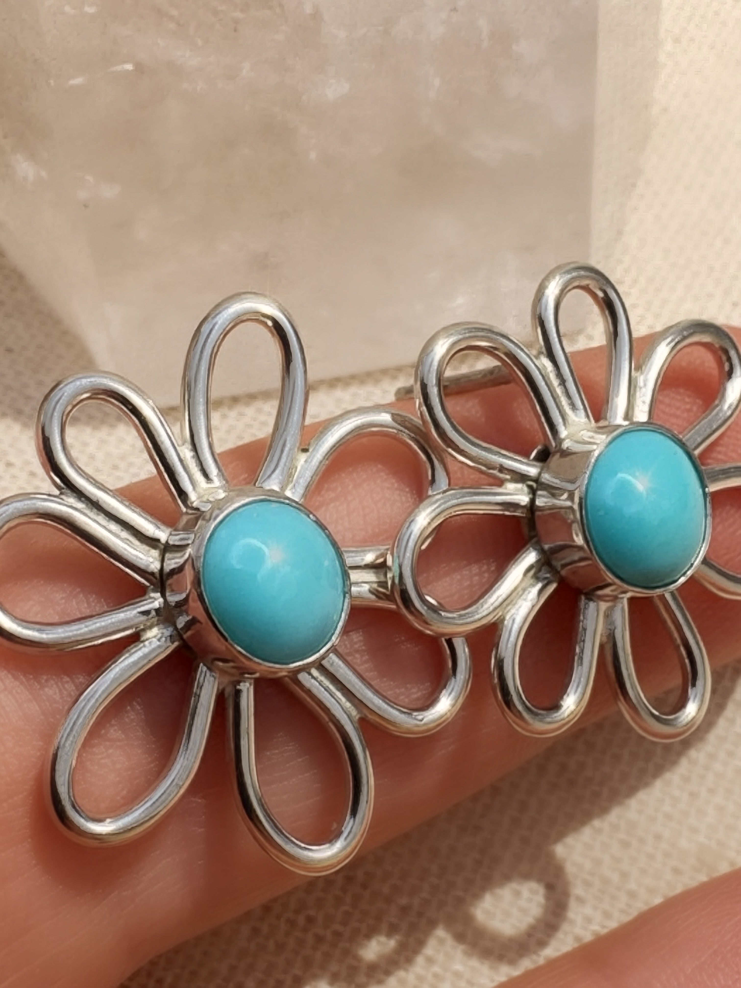 Pair of handmade sterling silver daisy stud earrings with robin's egg blue Sleeping Beauty turquoise cabochons