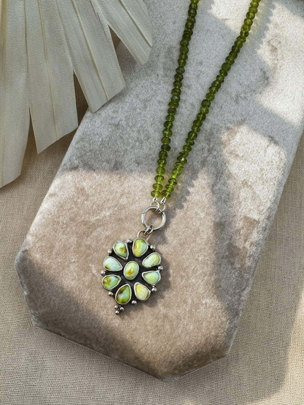 Verdant Sun statement necklace with nine green Palomino variscite stones, hand-knotted peridot beads and a sterling silver charm keeper.