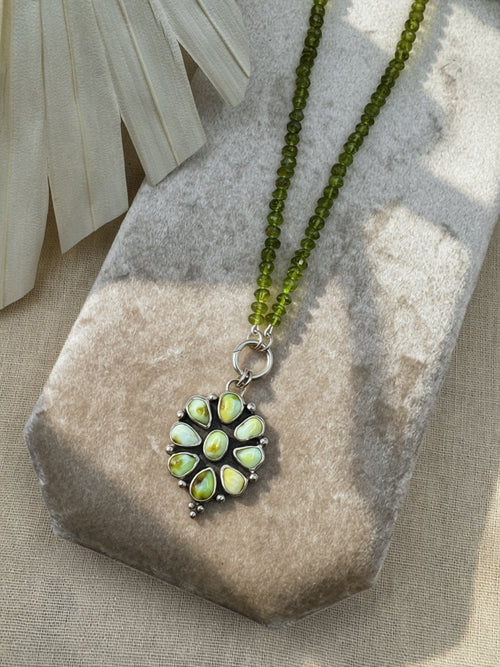 Verdant Sun statement necklace with nine green Palomino variscite stones, hand-knotted peridot beads and a sterling silver charm keeper.