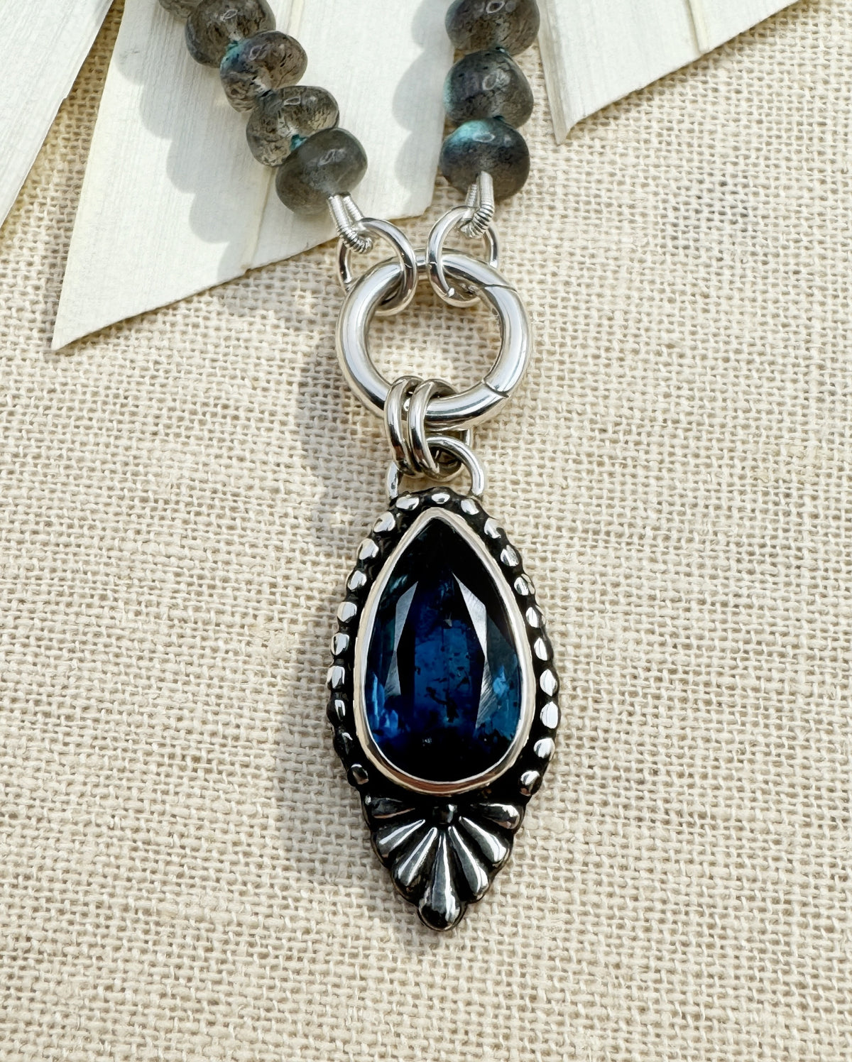 Full Blue Hour Bloom necklace with hand-knotted labradorite beads, sterling silver charm keeper and faceted teal kyanite floral pendant.
