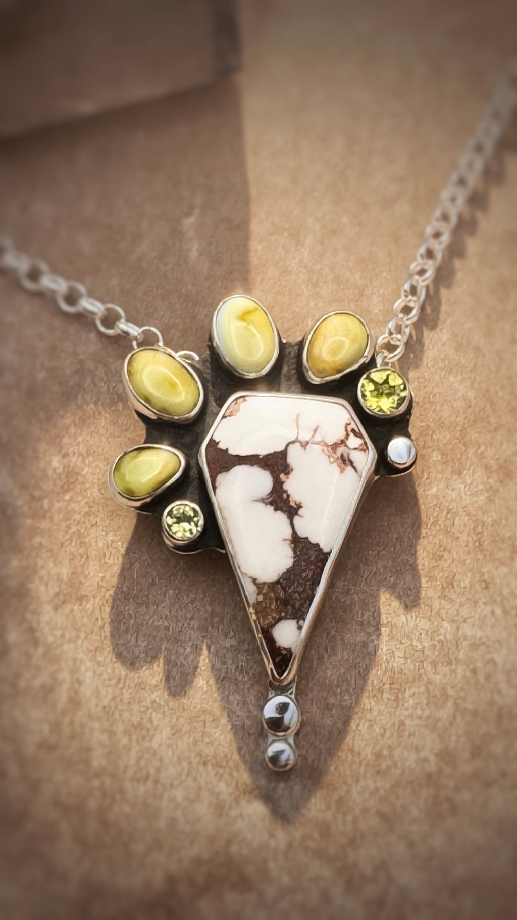 Close up on a neutral background of a  wild horse stone pendant necklace on 18-inch sterling silver chain