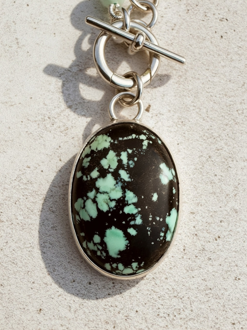Carico Lake Variscite oval cabochon with black matrix and mint-green, set in high-polish sterling silver bezel, Sun Salt Silver