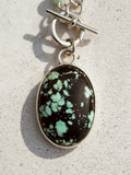 Carico Lake Variscite oval cabochon with black matrix and mint-green, set in high-polish sterling silver bezel, Sun Salt Silver
