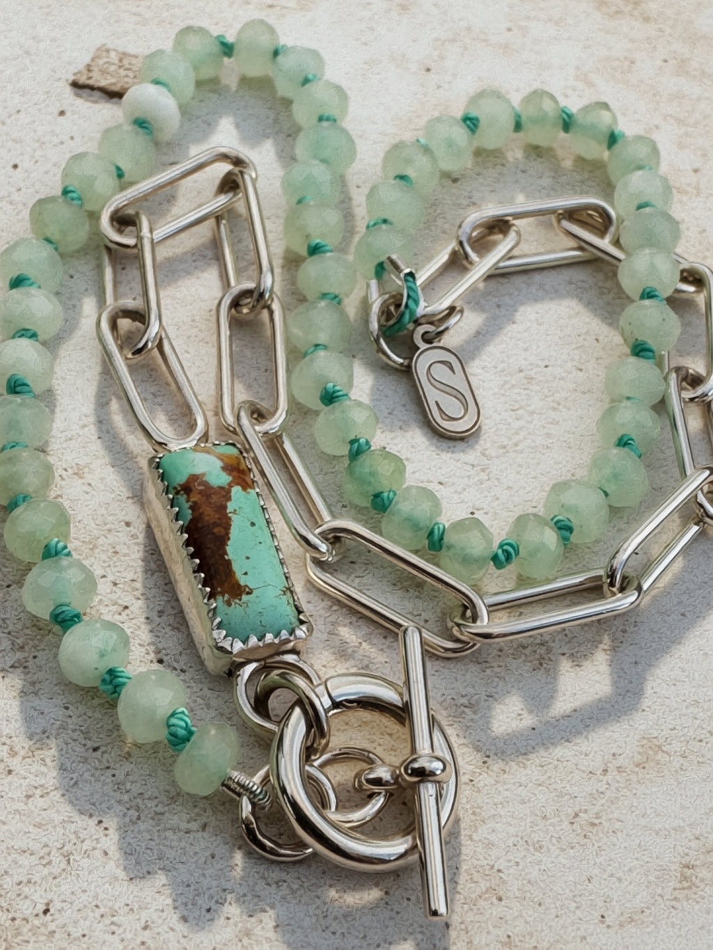 Glacier blue turquoise cabochon inline on sterling silver paperclip chain, worn to the side on hand-knotted seafoam bead necklace, Sun Salt Silver