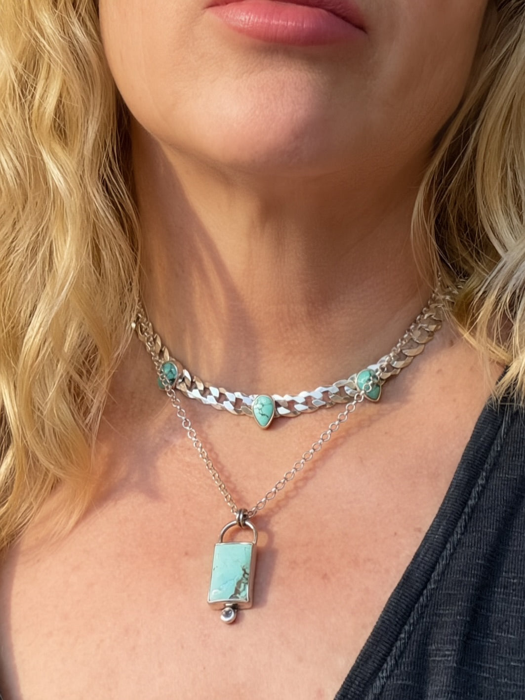 Blue Reign three-stone turquoise necklace worn with a separate rectangular turquoise pendant necklace.