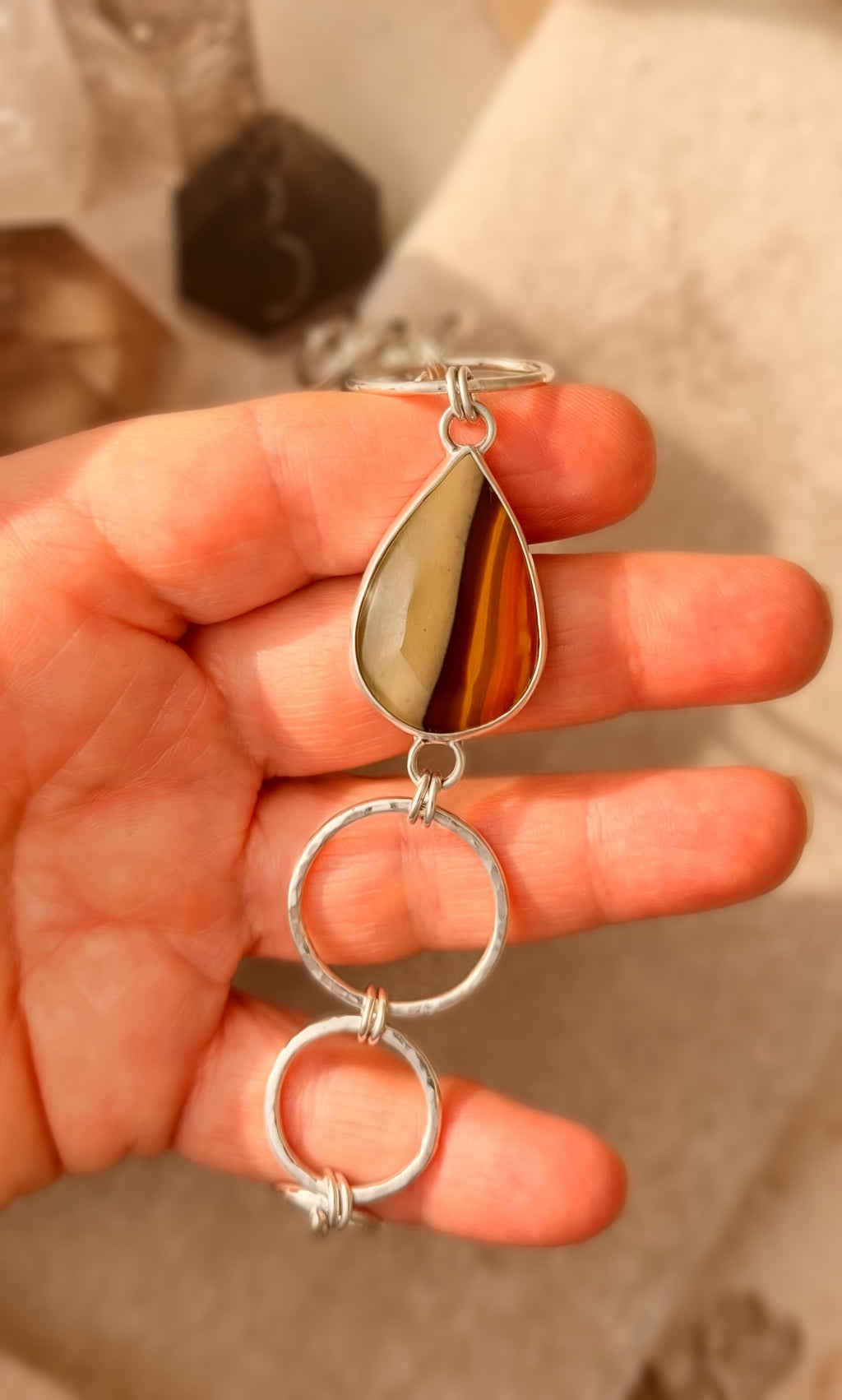 Silver and Jasper bracelet being held.