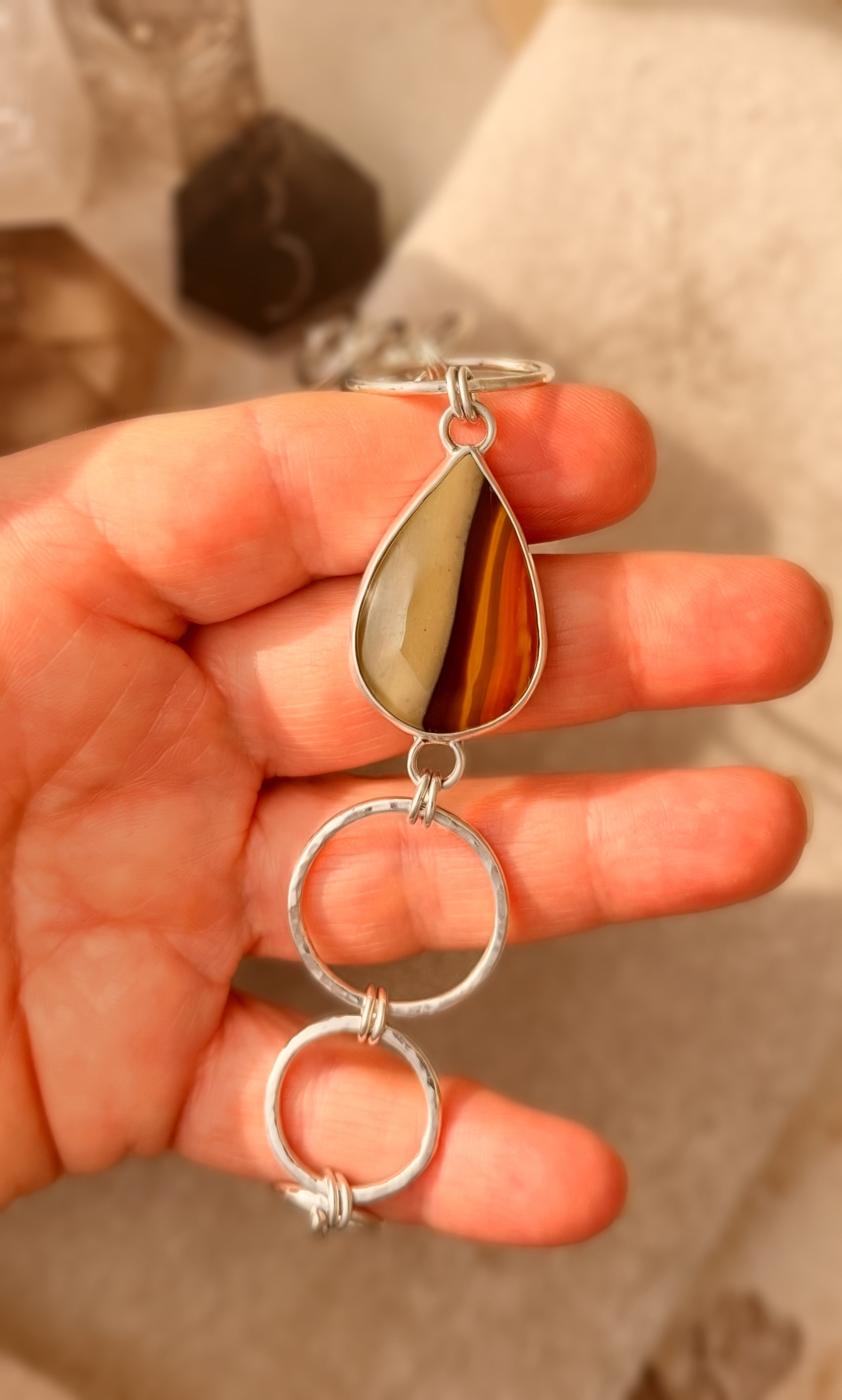 Silver and Jasper bracelet being held.