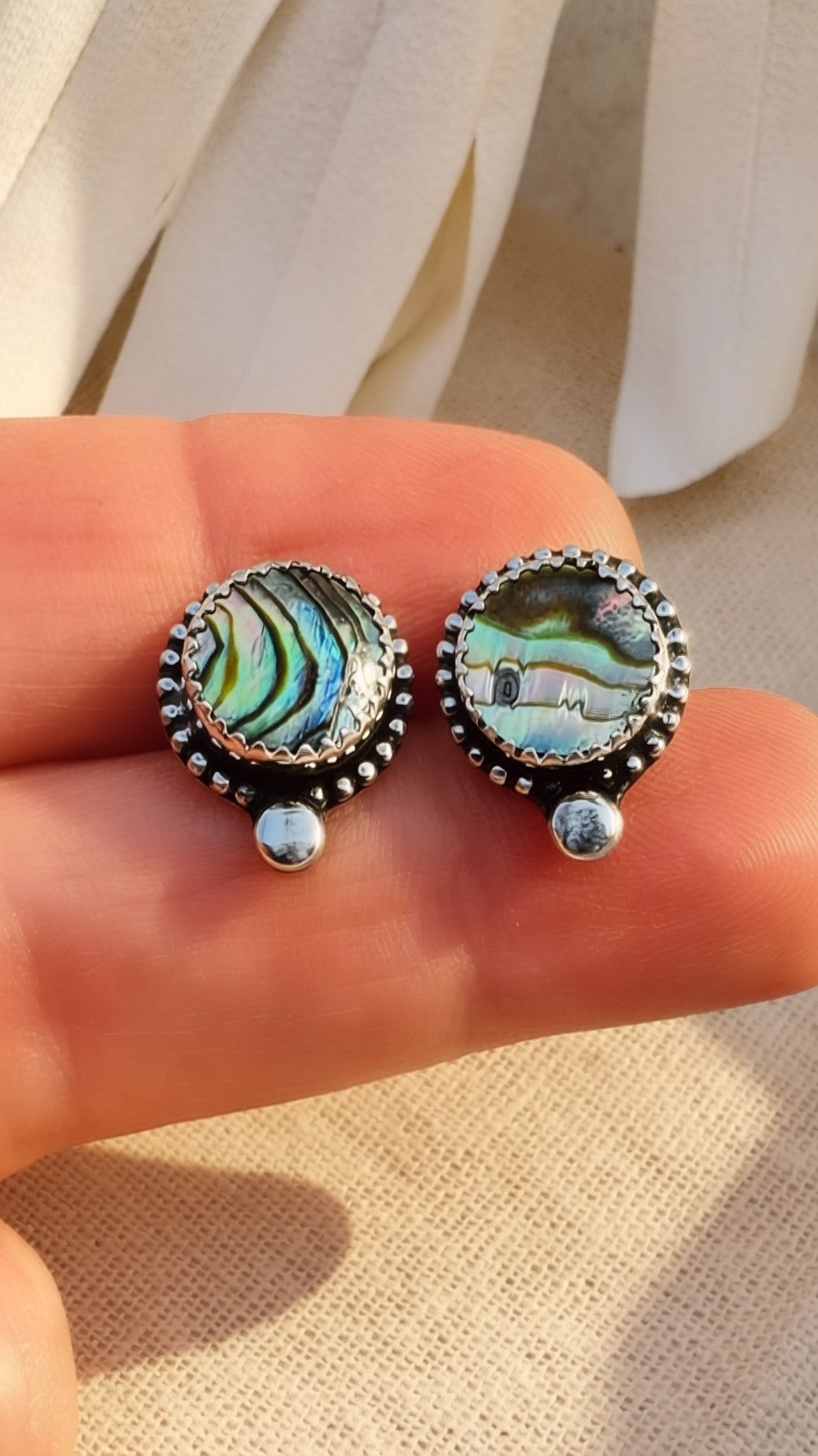 Handcrafted abalone shell post earrings with sterling silver bezel detail