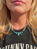 Handcrafted sterling silver curb chain necklace with Blue Dream and Sleeping Beauty turquoise bezel settings, worn at collarbone length