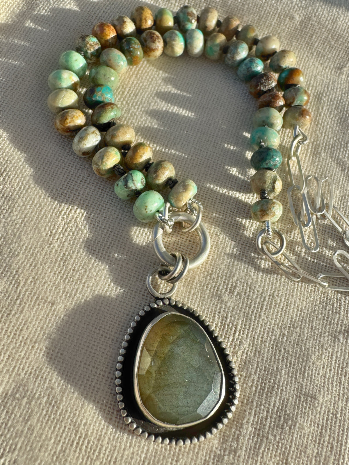 Desert Aurora necklace with turquoise beads hand-knotted on graphite silk, sterling paperclip chain and a rose-cut labradorite pendant.