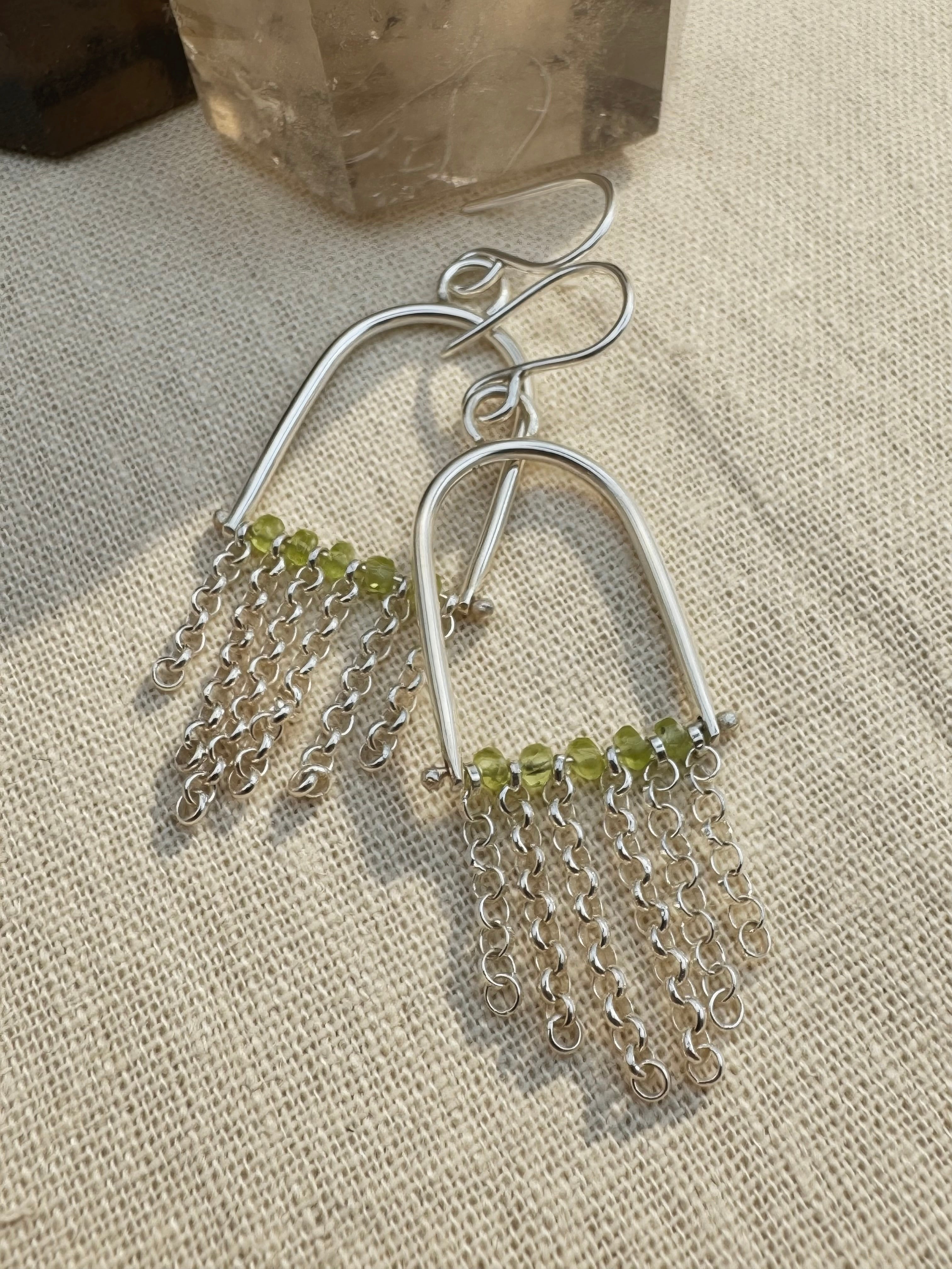 Hand-fabricated sterling silver arch earrings with Arizona Peridot beads and rolo chain fringe, 2.3" length, high-polish finish