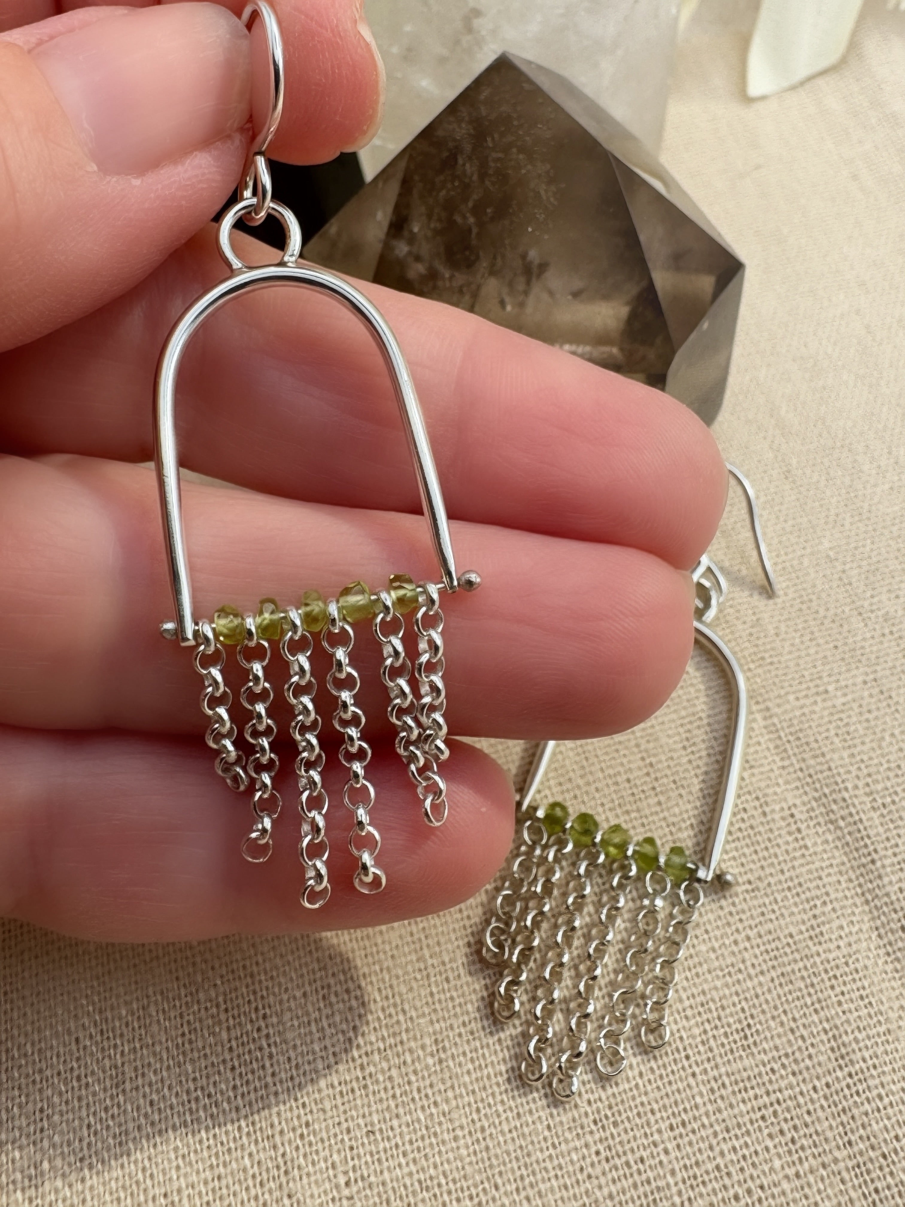 Hand-fabricated sterling silver arch earrings with Arizona Peridot beads and rolo chain fringe, 2.3" length, high-polish finish
