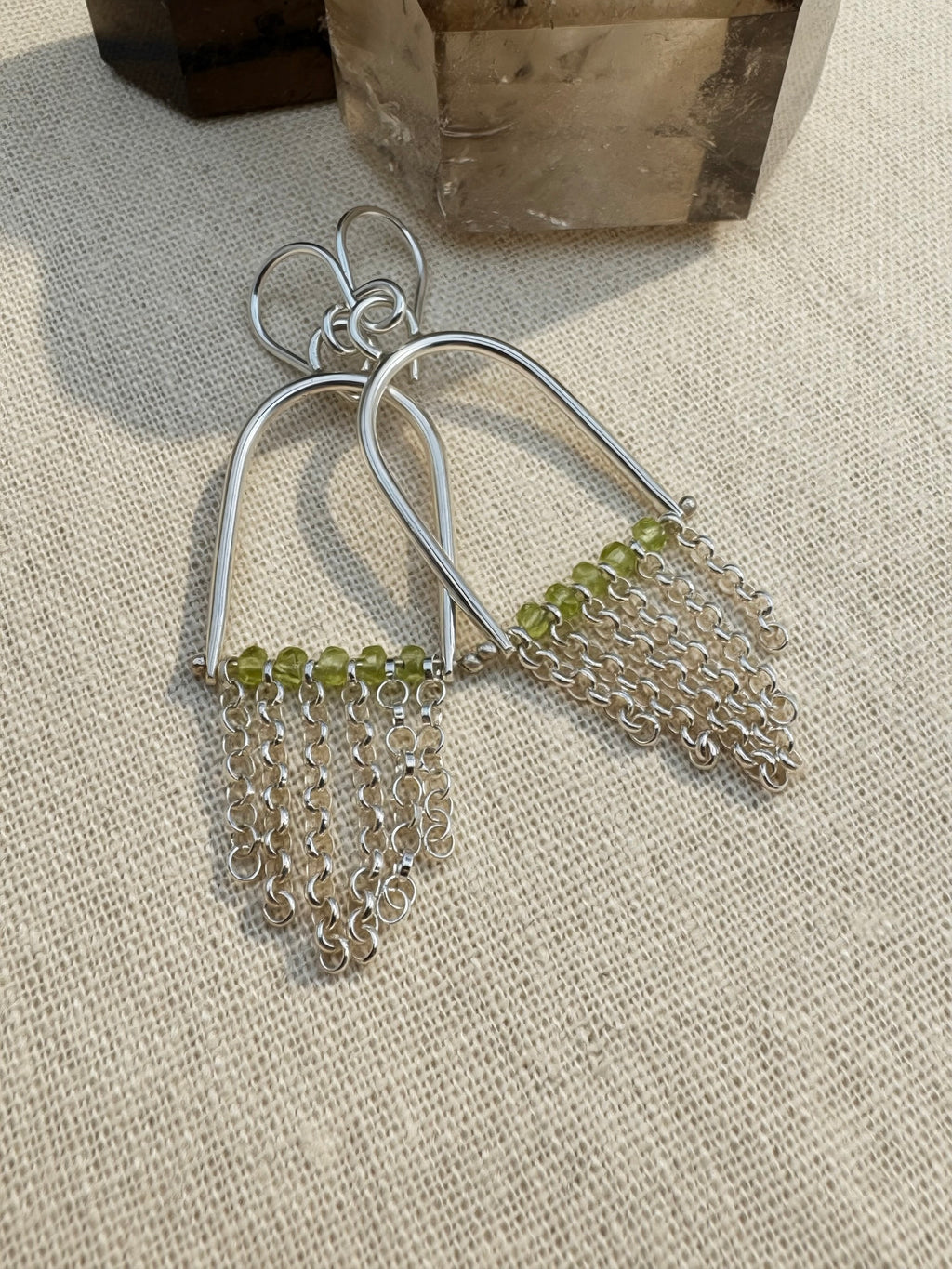 Hand-fabricated sterling silver arch earrings with Arizona Peridot beads and rolo chain fringe, 2.3" length, high-polish finish