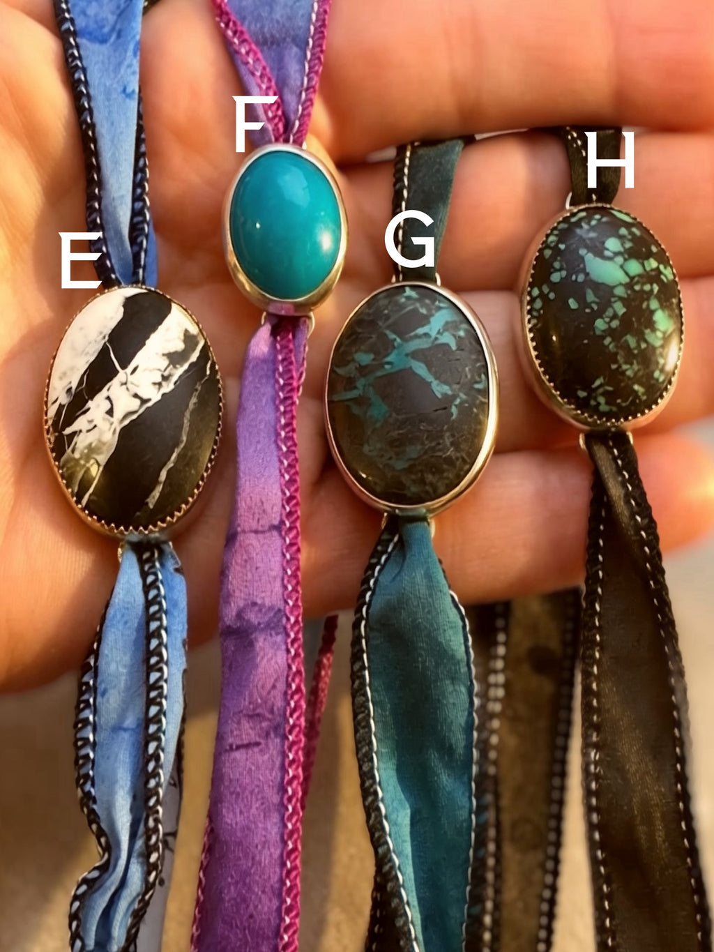 Natural stone silk wrap bracelets with white buffalo, turquoise, and boulder turquoise set in fine and sterling silver.