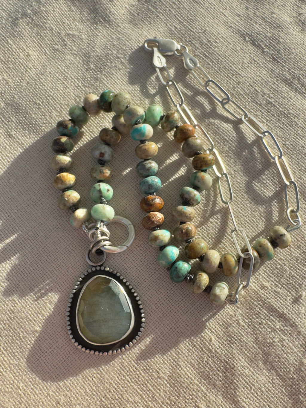 Desert Aurora necklace with turquoise beads hand-knotted on graphite silk, sterling paperclip chain and a rose-cut labradorite pendant.