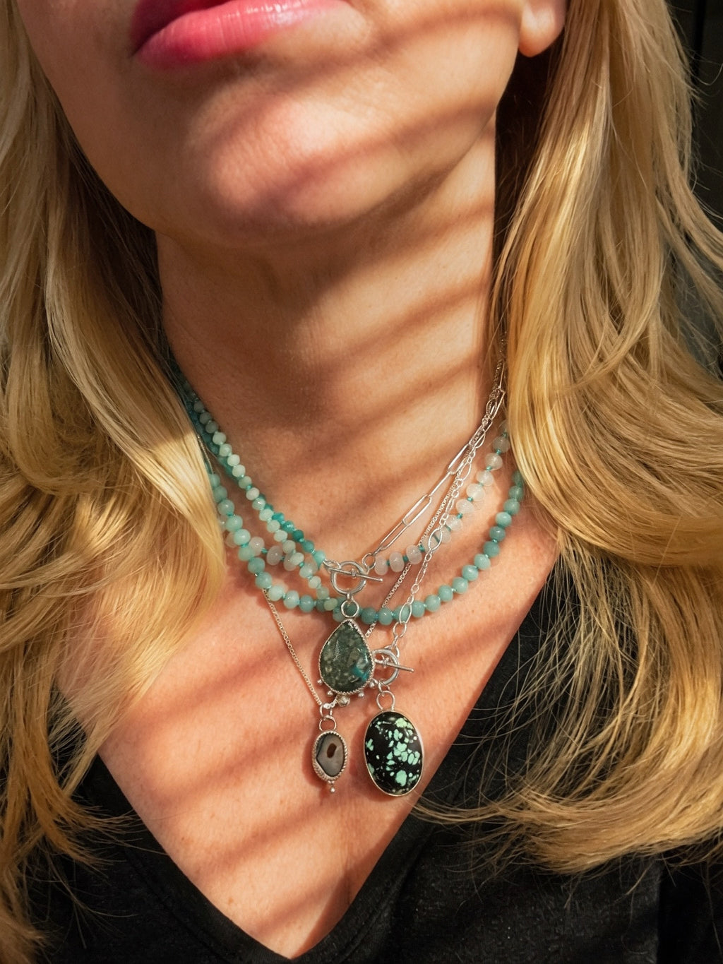 Beaded and Sterling silver layered necklaces being worn by a woman