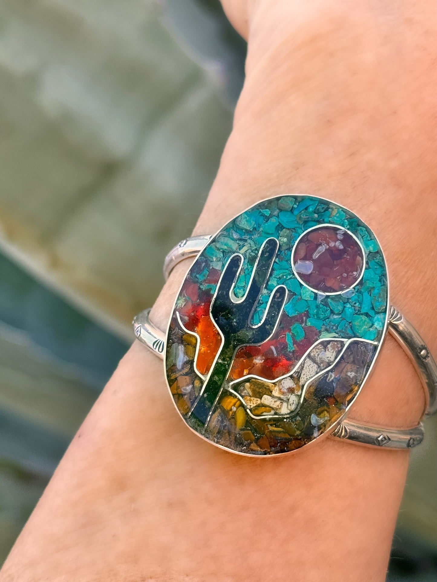 Inlay cuff bracelet of a desert scene and saguaro.