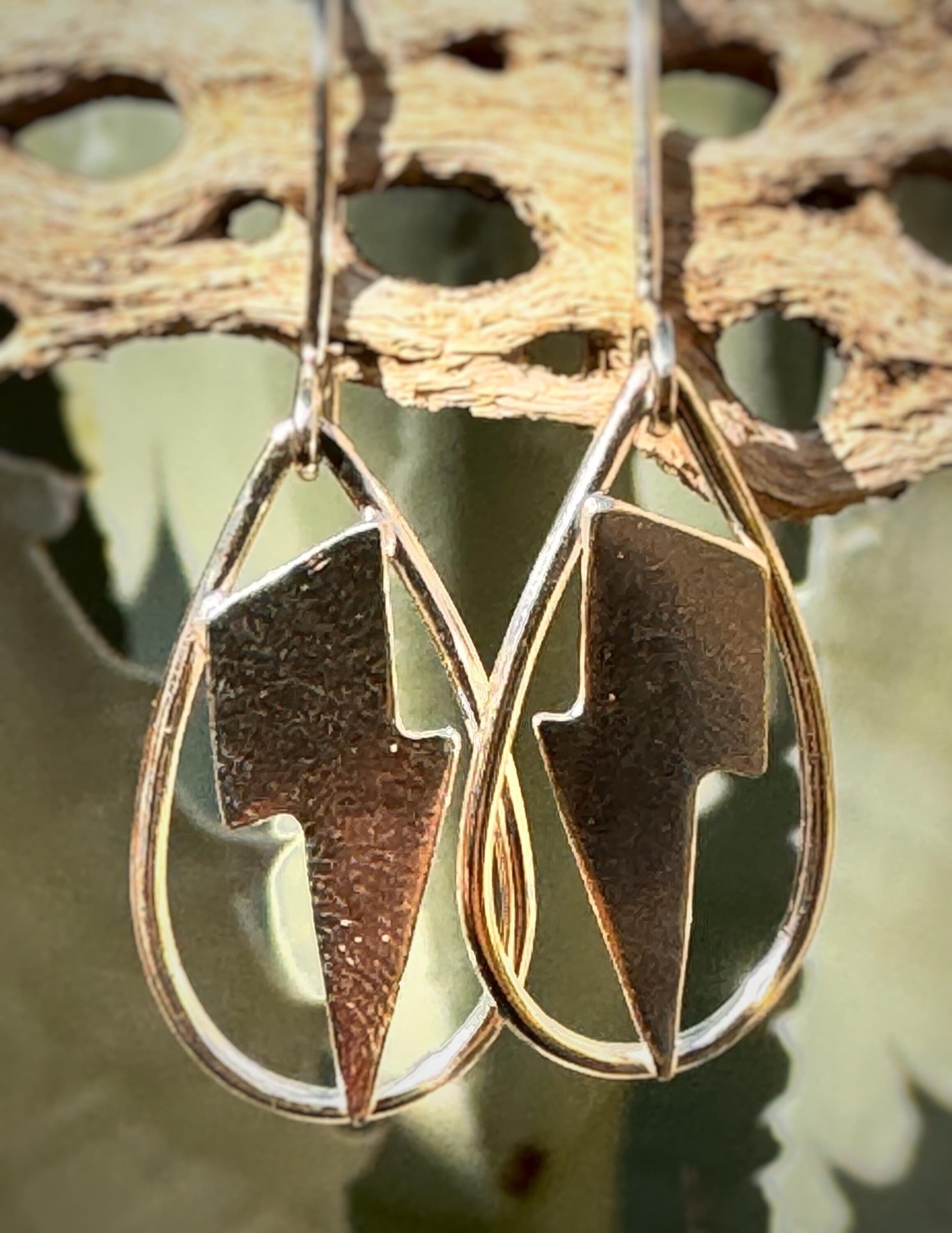 Silver lightning bolts in a teardrop hoop dangling earring