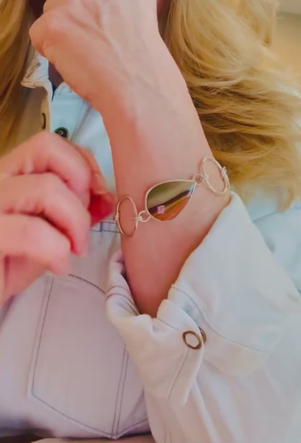Silver and jasper bracelet being adjusted on a woman’s wrist.