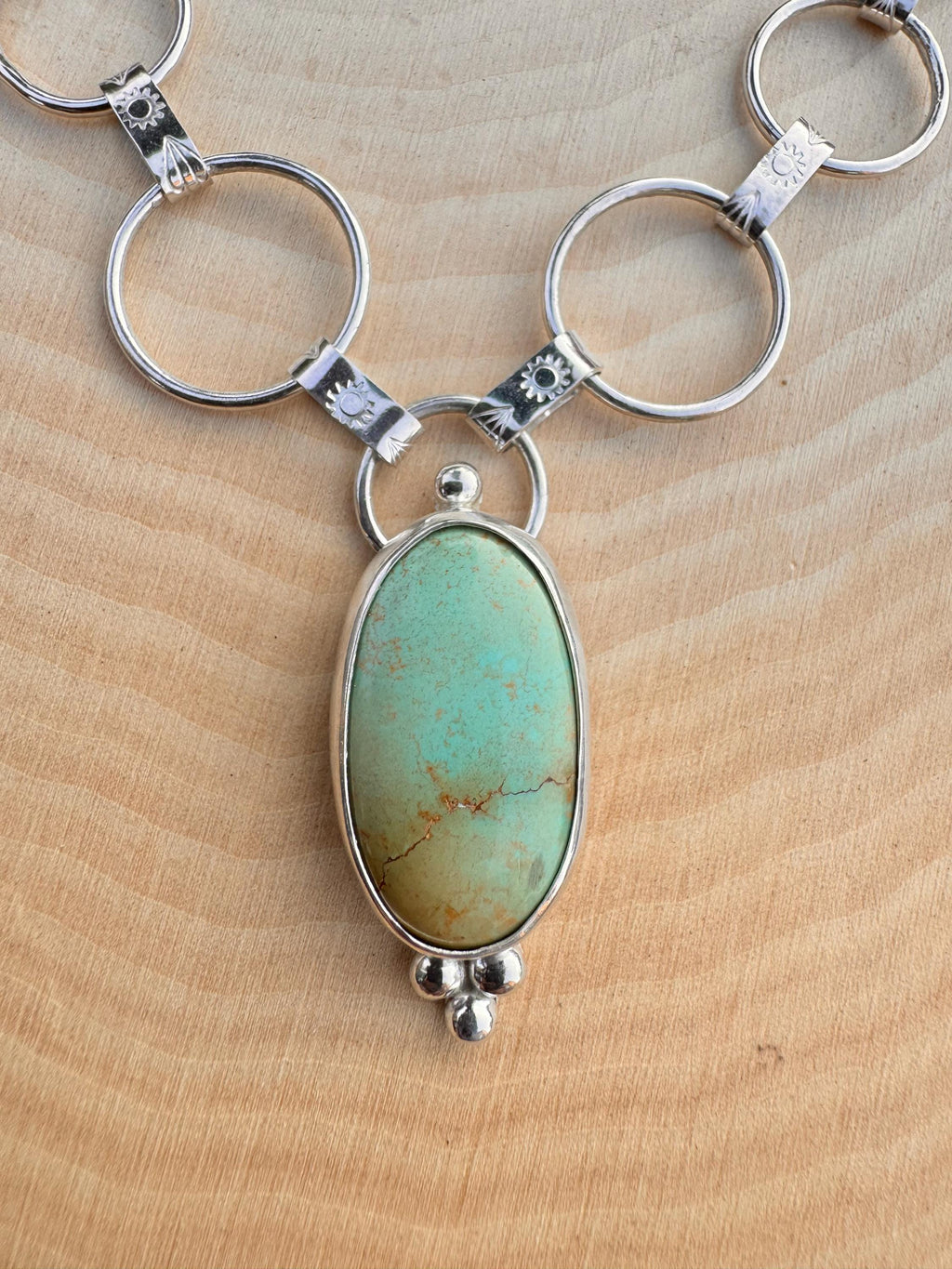 Artisan sterling silver chain with hand-forged textured links and Royston turquoise centerpiece.