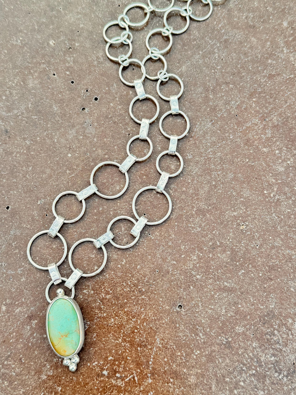 Artisan sterling silver chain with hand-forged textured links and Royston turquoise centerpiece.